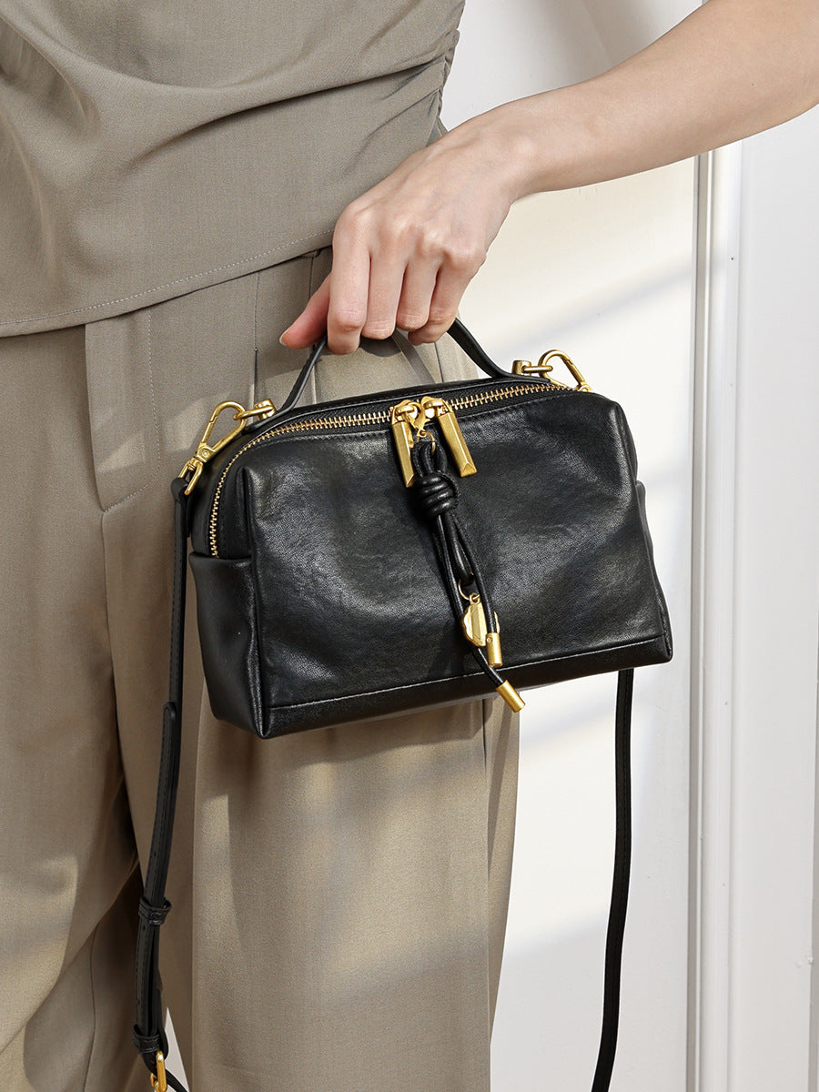 The Top-Handle Bag, carried by the top handle