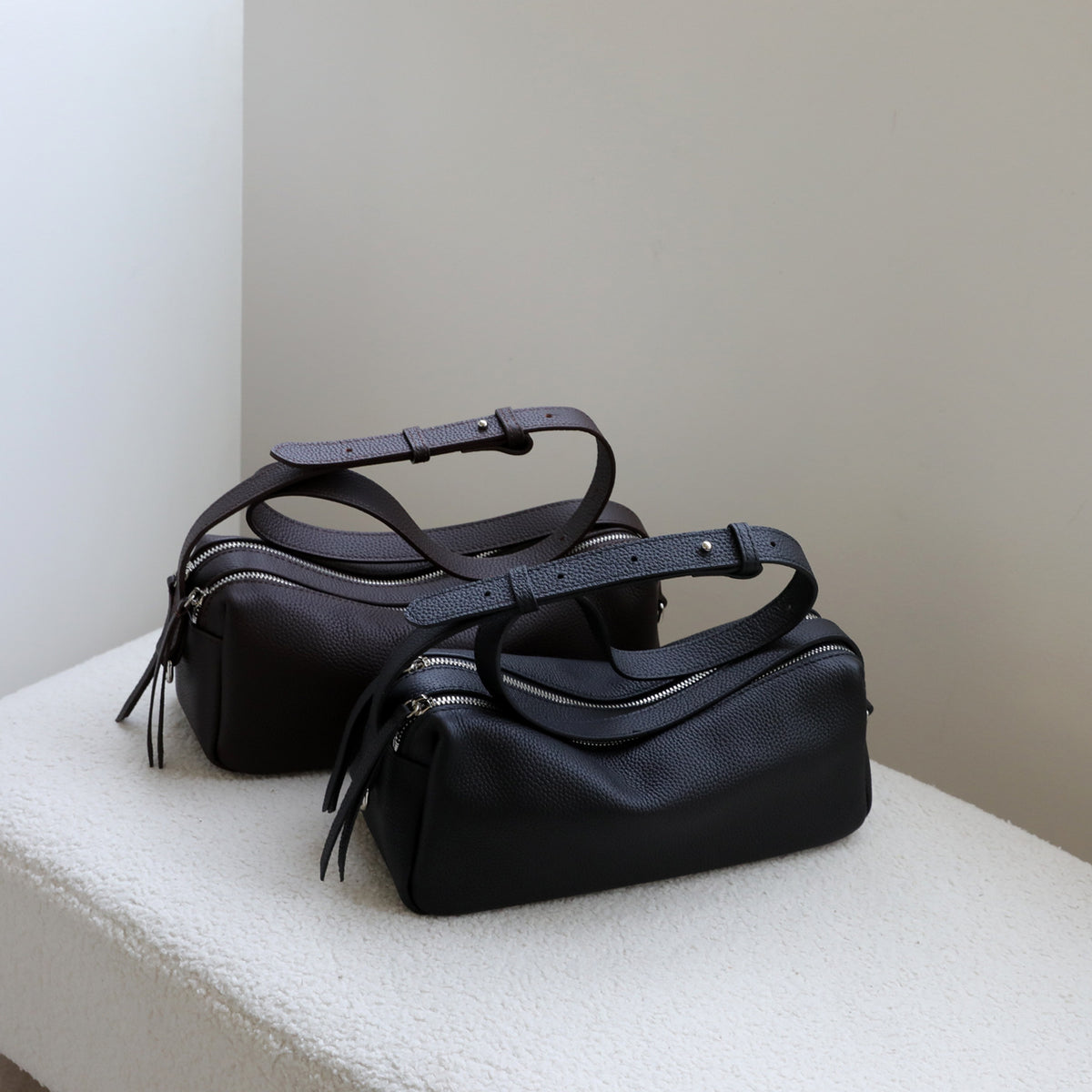 The Baguette Bag, shown in black and dark brown