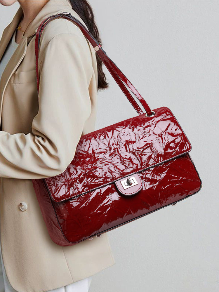 The Statement Flap Bag, worn by a model in wine