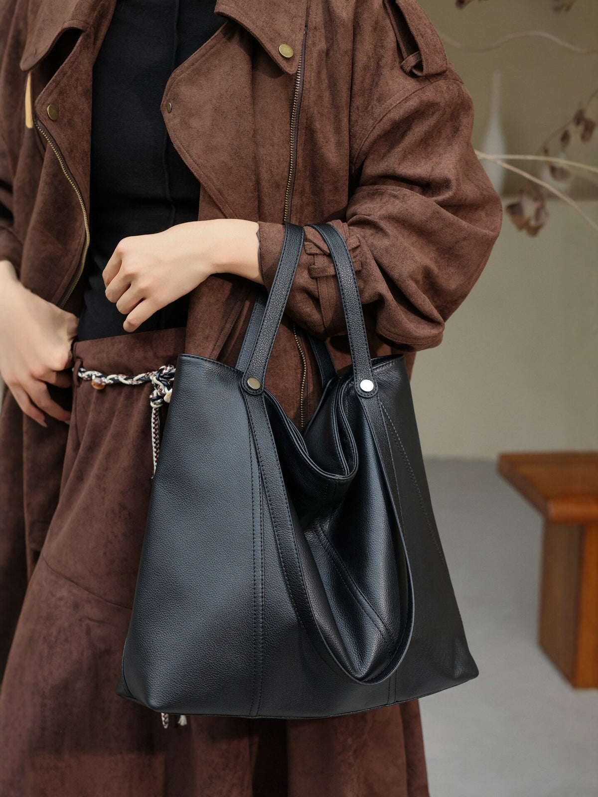 The Slouchy Tote, worn on the shoulder in black