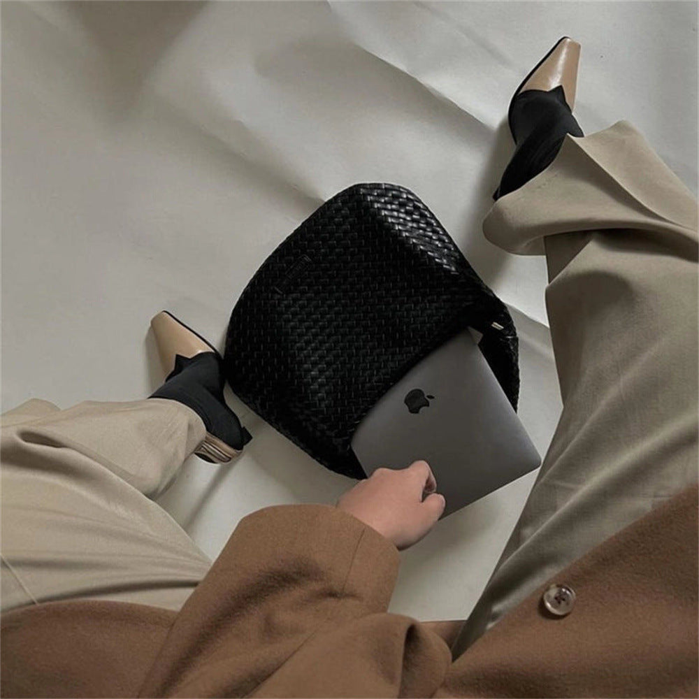The Ember Bag, in black, with heels and laptop