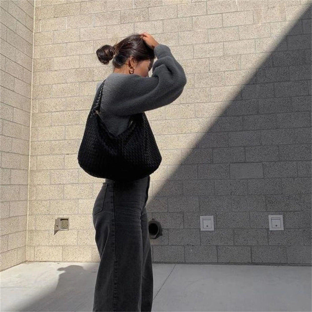 The Ember Bag, in black, worn on the shoulder