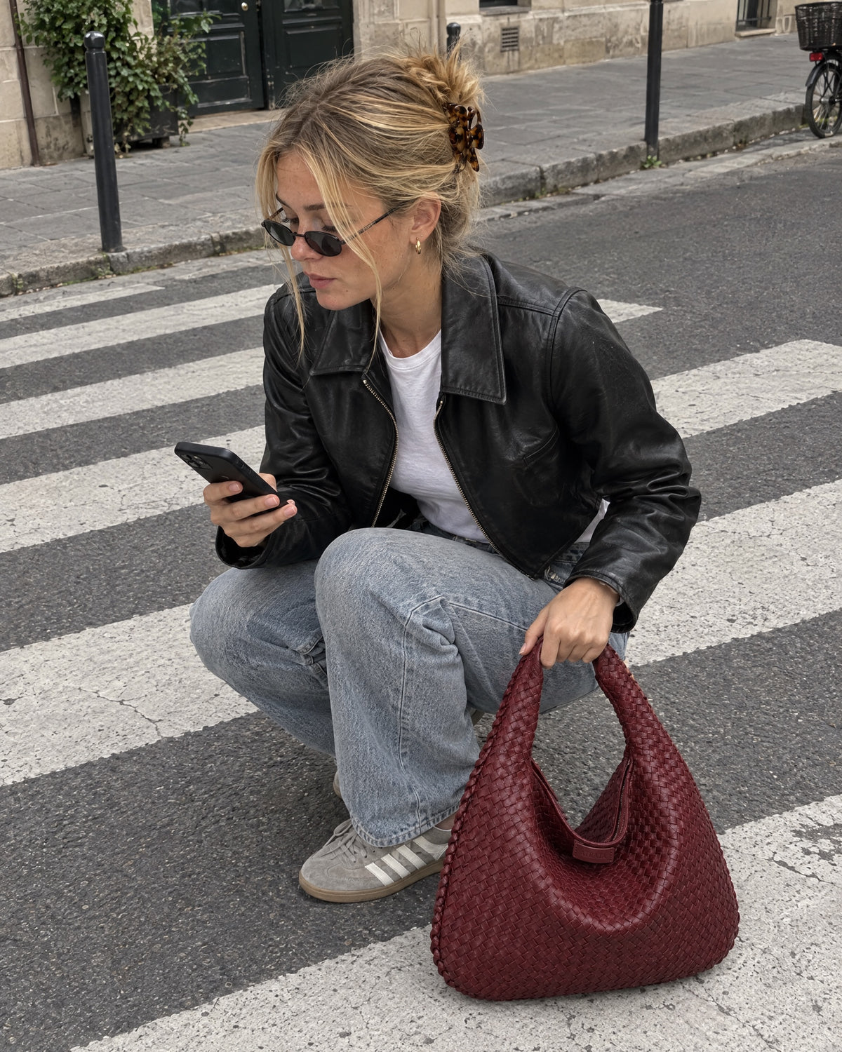 The Ember Bag, on the ground beside her on a city street