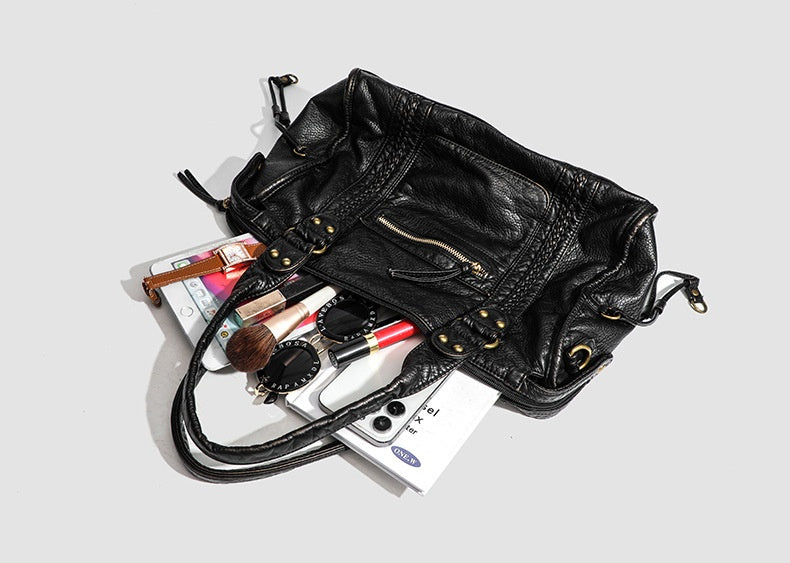 The Moonlit Bag, open, with everyday essentials spilling out