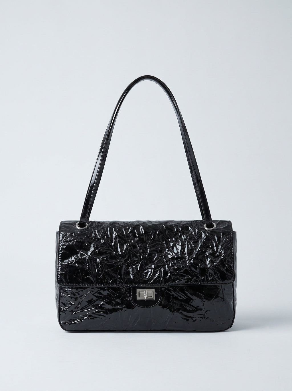 The Statement Flap Bag, front view in black