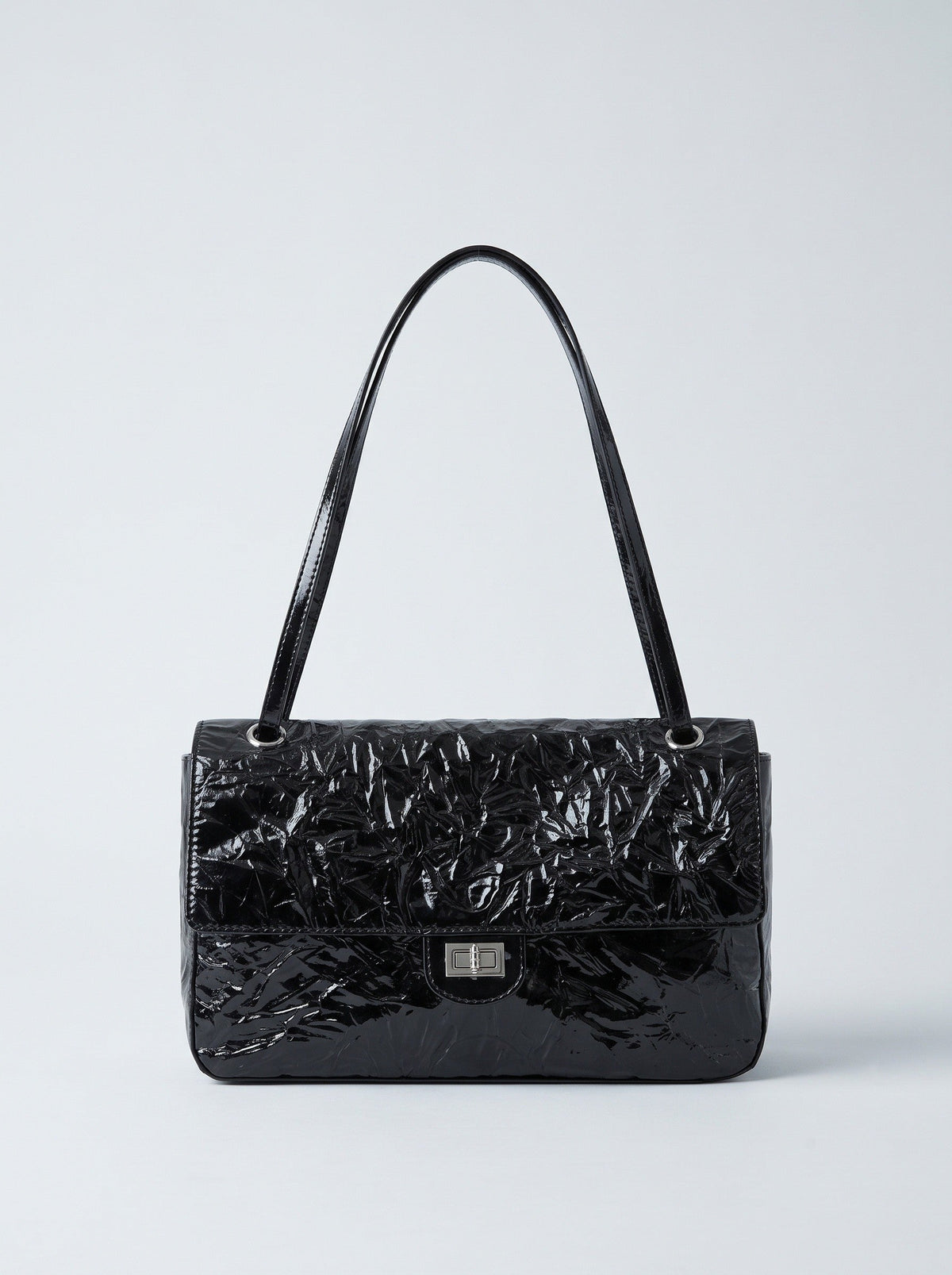 The Statement Flap Bag, front view in black