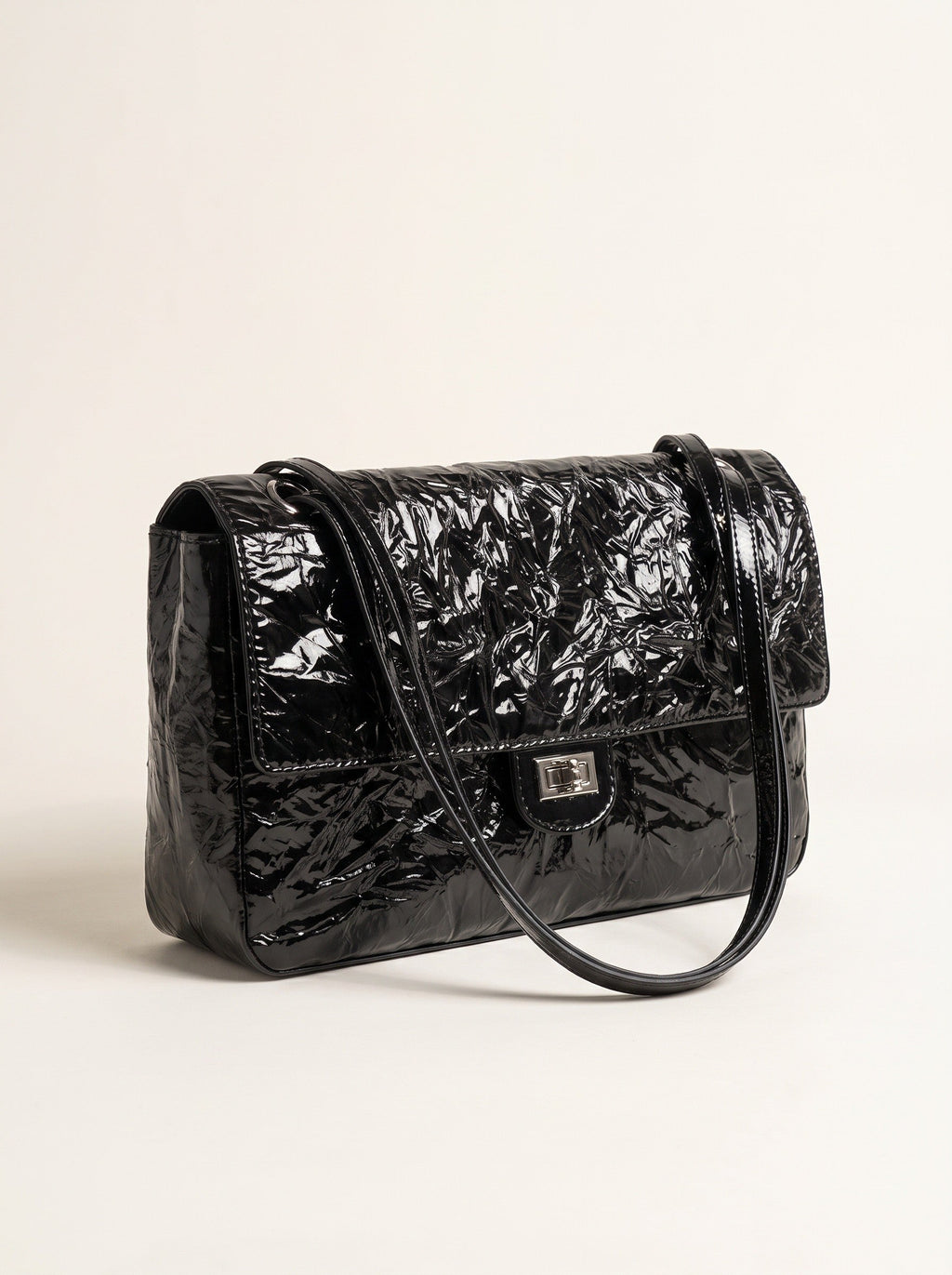 The Statement Flap Bag, three-quarter view in black