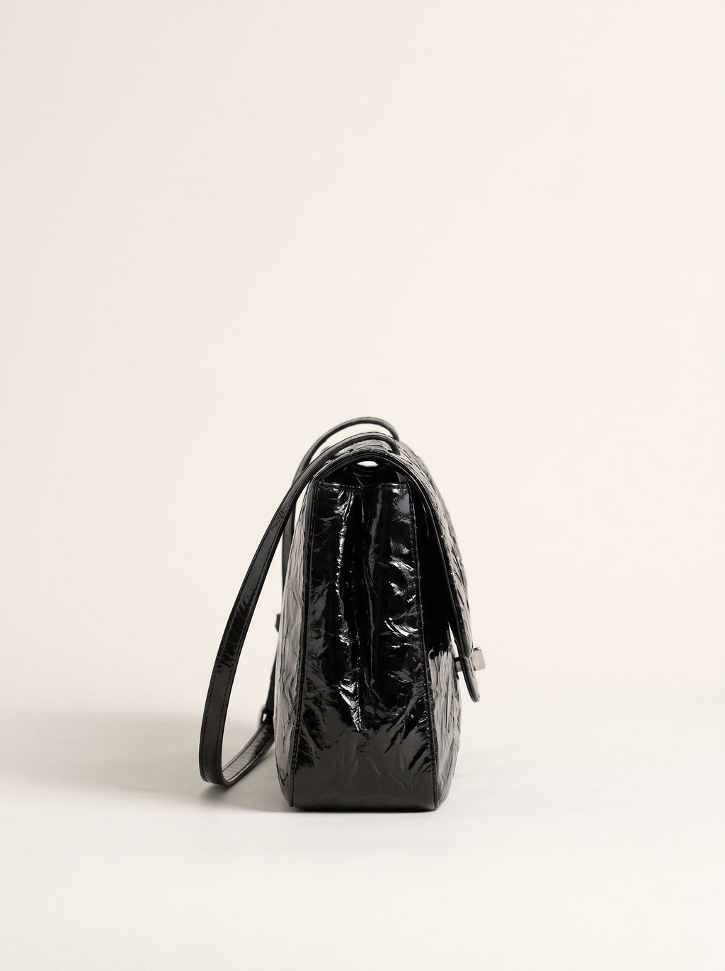 The Statement Flap Bag, side profile in black